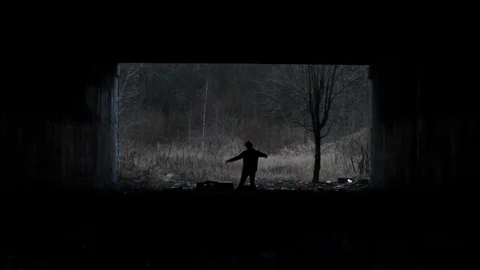 Zombie Walking Towards Camera in Abandoned Underpass Stock Footage 123863187