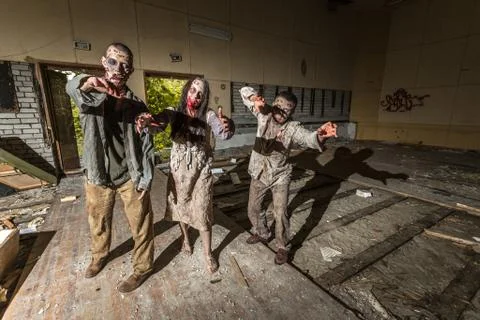 Zombies attack in an abandoned dark building Foto stock
