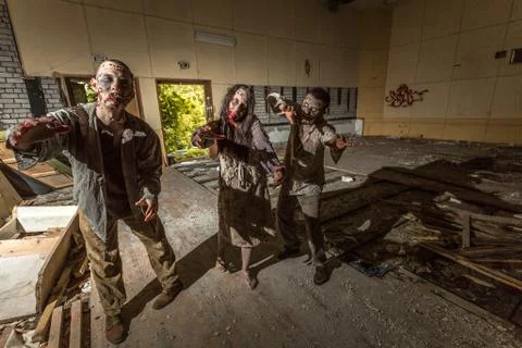 Zombies attack in an abandoned dark building Stock Photos