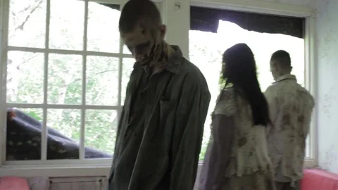 Zombies walk in the room of an abandoned house. Montage. Stock Footage
