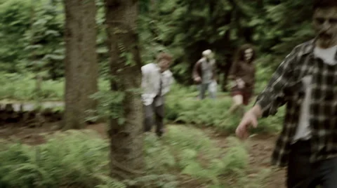 Zombies walking through forest wide shot Stock Footage 44130487