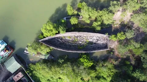 Zoom in on the aerial view of a large broken boat parked by the river Stock Footage 246777669