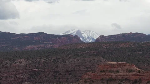 Zoom aerial view of snow capped La Sal Mountains in Moab Utah in spring Video stock 334349069