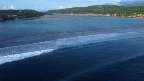 Zoom in and Crane Shot: waves entering a bay (Bali - Indonesia) Stock Footage 202133663