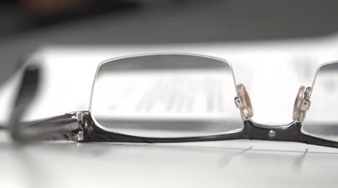 Zoom in and zoom out camera to the glass placed on paper. Stock Footage 60814272