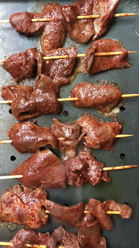 Zoom in on antichuchos on the grill Stock Footage 286168859