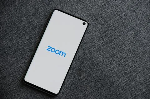 Zoom app on smartphone screen Stock Photos