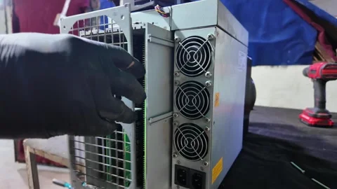 Zoom In on Assembly of Armando S19 Bitcoin Mining Machine Indoors Stock Footage 323789812