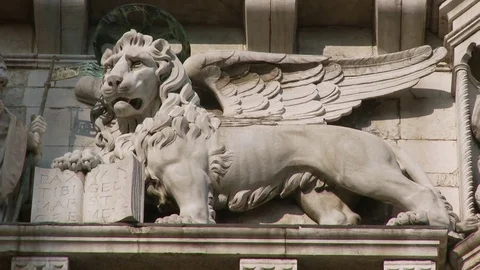 Zoom Back from close up of a statue of a  Doge kneeling the Lion of St Marks  Stock Footage 83399628