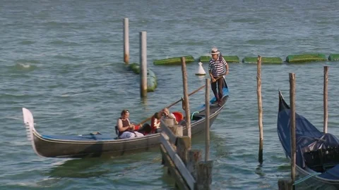 Zoom back on Gondolas at Saint Mark's Square looking towards San Giorgia Magg Stock Footage 83392829