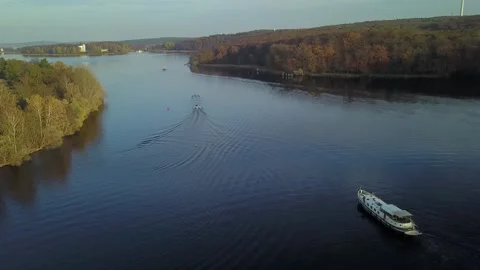 Zoom in on boat navigating Elbe Labe river through wide landscape Stock Footage 329162597