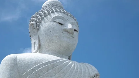 Zoom camera on the face of a large stone white Buddha statue Stock Footage 120416573