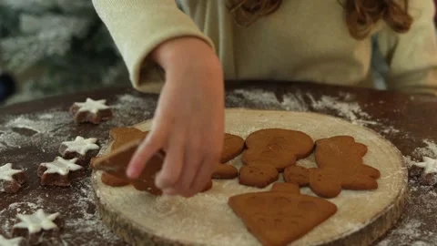 Zoom on child hands putting ginger homemade biscuits on a wooden plate, natural Stock Footage 256968799