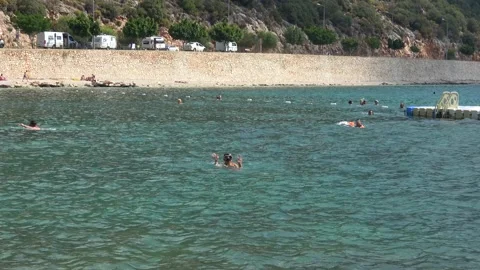 Zoom in a child throwing arms about in the sea waters Stock Footage 260465507