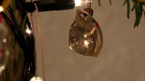 Zoom in: Close up of a damaged Christmas tree ball on a decorated Christmas tree Stock Footage 83897875