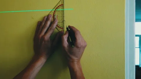 Zoom in to close up hand with ruler measures distance from lazer pointer Stock Footage 221023802