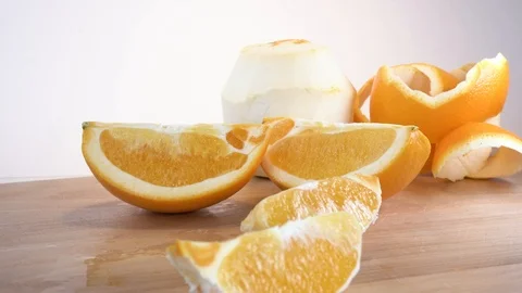 Zoom in close up pealed orange slices Stock Footage 124444806