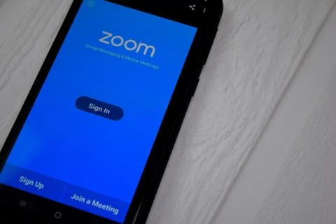 Zoom Cloud Meetings dev app on Smartphone screen. Stock Photos