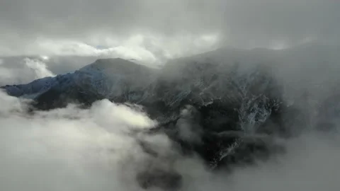 Zoom In  Clouds Rolling in Snowy Mountain Stock Footage 168304325
