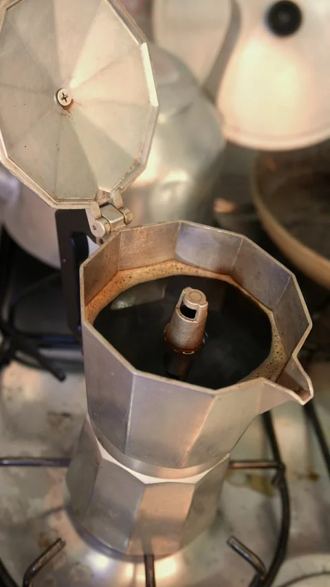 Zoom in: coffee steam rises from a moka pot in the kitchen. POV: making coffee Stock Footage 342365324