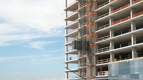 Zoom In of construction workers going up the elevator Stock Footage 80751067