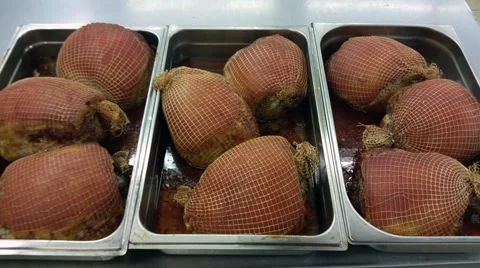 Zoom in on cooked pork hams, ready for christmas, at a restaurant kitchen Stock Footage 58487029