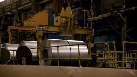 Zoom in Crane picks up rolls of steel Stock Footage 89944535