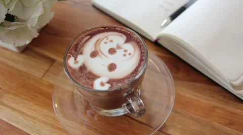 Zoom in  a cup of art latte at coffee shop, shape of a bear 스톡 동영상 50598699