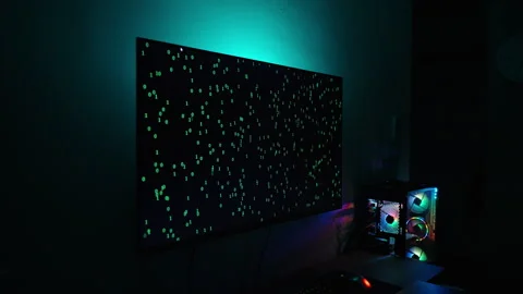 Zoom, Dark Room with Computer Setup, Monitor Showing Green Binary Code and Stock Footage 281461017