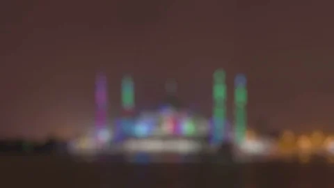 Zoom in defocused time lapse crystal mosque at night with light change Stock Footage 73168758