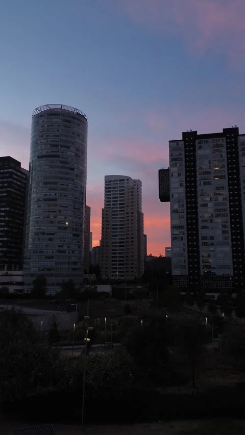 Zoom effect camera movement city skyline with high-rise towers during twilight Stock Footage 313079986