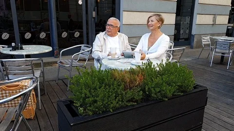 Zoom in eldelry couple wearing white clothes and sitting Stock Footage 127182423