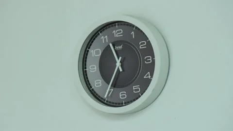 Zoom in of electric clock on white wall in empty office Stock Footage 138895654