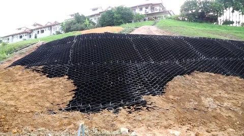 Zoom in into erosion control grids from steep slope in erosion management Stock Footage 56880379