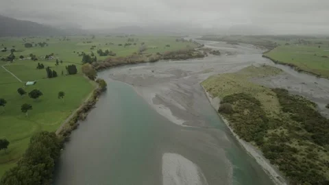 Zoom establishing shot of braided river near Kokatahi, New Zealand. Drone 4K Stock Footage 240515818