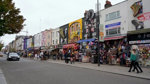 ZOOM IN to the famous wall decorations above tourist shops on Camden High Str Stock Footage 129285203