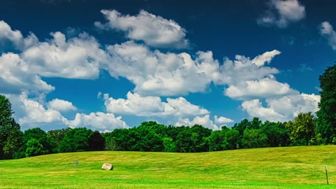 Zoom In On Fast-moving clouds against a blue sky - Timelapse Stock Footage 203834634