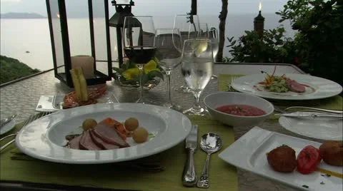 Zoom into food on table overlooking ocean Stock Footage 22665003