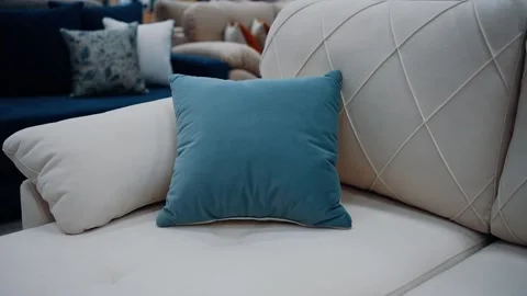 Zoom frame to a soft blue pillow sitting on a white couch. Minimalistic concept Stock Footage 235056536