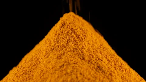 Zoom frame sprinkle orange powder turmeric, isolated on black background Stock Footage 260394650