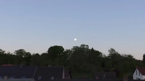 Zoom in: Full moon seen above Otterbach, a small rural German village Stock Footage 76770081