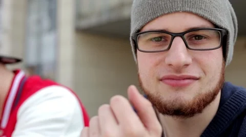 Zoom In on guy which is looking into lens and smiling. Video stock 49535892