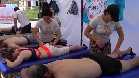 Zoom in having sport massage of buttocks Stock Footage