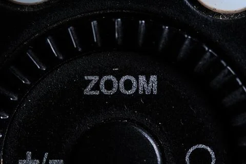 The zoom icon button is close on the flash for camera device. Old and dirty Stock Photos