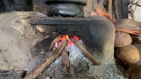 Zoom in making a curry in a clay pot on a hot traditional hearth Stock Footage 202864750