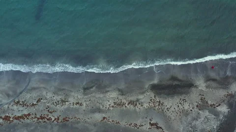 Zoom In Of Man Walking Through Surf Of Funningur Stock Footage 134286136