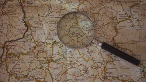 Zoom on map with zoom lens Stock Footage 77617086