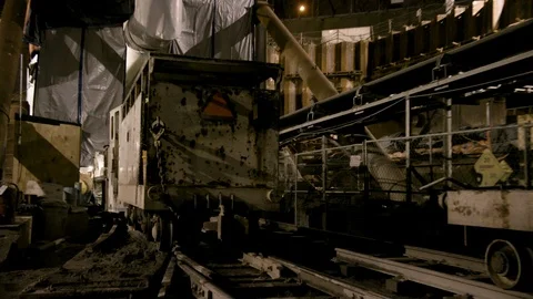 Zoom in on Mining railway car moving away from camera Stock Footage 89944478