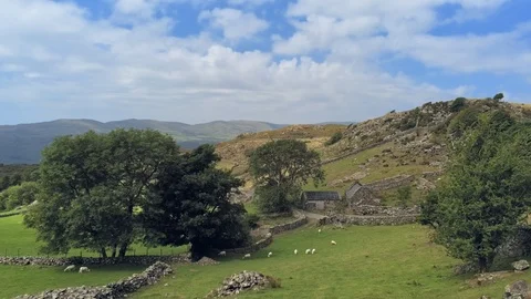 Zoom in move. Shadow of clouds move fast, ancient welsh stone building in mou Stock Footage 94259139