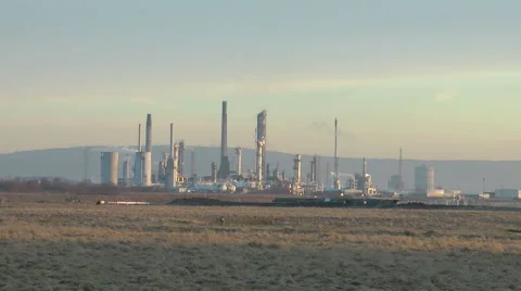 Zoom into Oil Refinery, reflections of sunset on metal columns, Stock Footage 1045808